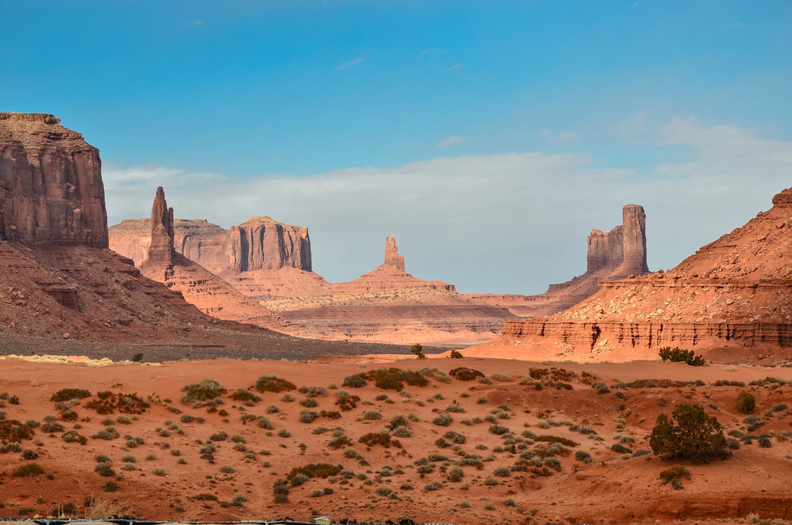 Sunlit desert dunes with long sculptural shadows